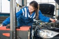 Female Mechanic Aligning Headlights Royalty Free Stock Photo