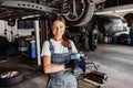 A Female Mechanic Engaged in Work at an Auto Shop Surrounded by Various Tools and Equipment Royalty Free Stock Photo