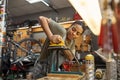 Female mechanic fix bike tube in bicycle workshop