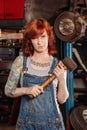 Female mechanic holding rubber mallet Royalty Free Stock Photo