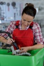 female mechanic repairing car in body shop