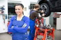 Female mechanic standing in a garage