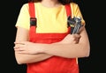 Female mechanic in uniform with instruments on black background, closeup Royalty Free Stock Photo