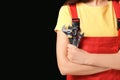 Female mechanic in uniform with instruments on black background, closeup Royalty Free Stock Photo