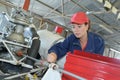Female mechanic working on helicopter engine Royalty Free Stock Photo