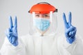 Female medic in protective suit gesturing victory Royalty Free Stock Photo