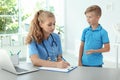 Female medical assistant consulting child Royalty Free Stock Photo