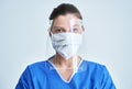 Portrait of female medical doctor wearing protective mask and face shield Royalty Free Stock Photo