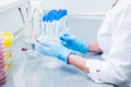 Female medical or scientific laboratory researcher performs tests. Close up, selective focus