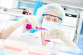 Female medical scientific researcher holding flask