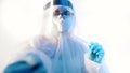 Female medical technician in protective suit taking nasal swab covid19 test from the patient