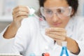 female medical worker compares test tubes with biological samples