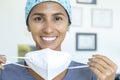 Female medical worker smiles removing surgical mask Royalty Free Stock Photo