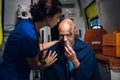 A female medical worker talking to a man rescued from the fire Royalty Free Stock Photo