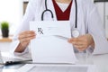 Female medicine doctor hand hold clipboard pad and give prescription to patient closeup. Panacea and life save Royalty Free Stock Photo