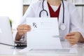 Female medicine doctor hand hold clipboard pad and give prescription to patient closeup. Panacea and life save Royalty Free Stock Photo