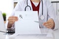 Female medicine doctor hand hold clipboard pad and give prescription to patient closeup. Panacea and life save Royalty Free Stock Photo