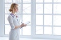 Female medicine doctor hand holding pen writing something on clipboard closeup. Royalty Free Stock Photo