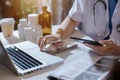 Female medicine doctor hand holding silver pen writing something on clipboard closeup. Royalty Free Stock Photo