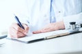 Female medicine doctor hand holding silver pen writing something on clipboard closeup.. Ward round, patient visit check Royalty Free Stock Photo