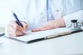 Female medicine doctor hand holding silver pen writing something on clipboard closeup.. Ward round, patient visit check Royalty Free Stock Photo