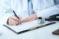 Female medicine doctor hand holding silver pen writing something on clipboard closeup.. Ward round, patient visit check Royalty Free Stock Photo