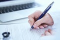 Female medicine doctor hand holding silver pen writing something on clipboard closeup.. Ward round, patient visit check Royalty Free Stock Photo