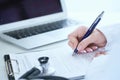 Female medicine doctor hand holding silver pen writing something on clipboard closeup.. Ward round, patient visit check Royalty Free Stock Photo