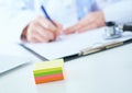 Female medicine doctor hand holding silver pen writing something on clipboard closeup.. Ward round, patient visit check Royalty Free Stock Photo