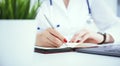 Female medicine doctor hand holding silver pen writing something on clipboard and working laptop closeup. Physician Royalty Free Stock Photo