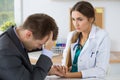 Female medicine doctor holding business man hand for encouragement