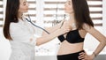 Female medicine doctor holding stethoscope to pregnant woman standing for encouragement, empathy, cheering,support