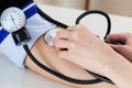 Female medicine doctor measuring blood pressure to patient Royalty Free Stock Photo