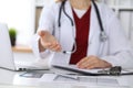 Female medicine doctor offering helping hand in office closeup. Physician ready to examine and save patient. Friendly Royalty Free Stock Photo