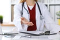 Female medicine doctor offering helping hand in office closeup. Physician ready to examine and save patient. Friendly Royalty Free Stock Photo