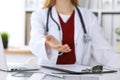 Female medicine doctor offering helping hand in office closeup. Physician ready to examine and save patient. Friendly Royalty Free Stock Photo