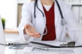 Female medicine doctor offering helping hand in office closeup. Physician ready to examine and save patient. Friendly Royalty Free Stock Photo