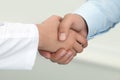 Female medicine doctor shaking hands with male patient.