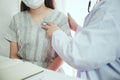 Female medicine doctor working on table with consulting patient. Wearing mask to patient for prevent Covid 19. Royalty Free Stock Photo