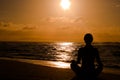 Female meditating on the beach Royalty Free Stock Photo