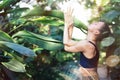 Female meditating and practicing yoga in tropical rainforest. Beautiful young woman practicing yoga outdoor with Royalty Free Stock Photo