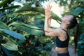 Female meditating and practicing yoga in tropical rainforest. Beautiful young woman practicing yoga outdoor with Royalty Free Stock Photo