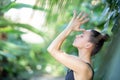 Female meditating and practicing yoga in tropical rainforest. Beautiful young woman practicing yoga outdoor with Royalty Free Stock Photo