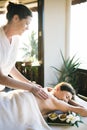 Female message therapist giving a massage at a spa