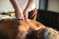 Female message therapist giving a massage at a spa