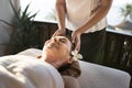 Female message therapist giving a massage at a spa