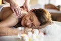 Female message therapist giving a massage at a spa