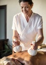 Female message therapist giving a massage at a spa