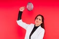 Female with metal sieve for sifting flour in a female hand on red and white background. Royalty Free Stock Photo