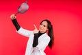 Female with metal sieve for sifting flour in a female hand on red and white background. Royalty Free Stock Photo